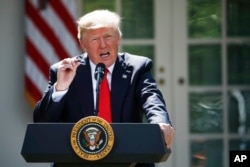 President Donald Trump speaks about the U.S. role in the Paris climate change accord, June 1, 2017, in the Rose Garden of the White House in Washington.