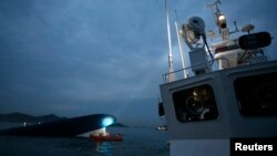 FILE - The South Korean ferry "Sewol" is seen sinking in the sea off Jindo, South Korea, April 16, 2014. 