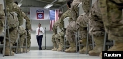 FILE - U.S. Defense Secretary Ash Carter talks to U.S. troops from the 82nd Airborne Division at the Baghdad International Airport in Baghdad, Iraq, July 23, 2015.
