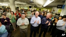 Seattle Times staffers applaud a speech in the paper's newsroom, April 20, 2015, after it was announced that the newspaper's staff had won the Pulitzer Prize for breaking news reporting for its coverage of the mudslide in Oso, Washington, that killed 43 people and its exploration of whether the disaster could have been prevented.
