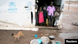 FILE - South Sudanese refugee children look out of a transit tent at the Imvepi refugee settlement camp in Arua District, northern Uganda, Aug. 22, 2017.