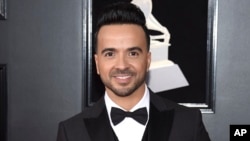 FILE - Luis Fonsi arrives at the 60th annual Grammy Awards in New York, Jan. 28, 2018. 