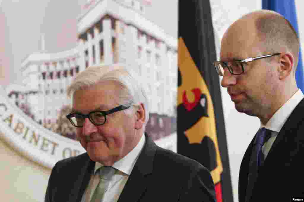 Menteri Luar Negeri Jerman Frank-Walter Steinmeier (kiri) dan Perdana Menteri Ukraina Arseniy Yatsenyuk menghadiri konferensi pers di Kyiv (18/11). (Reuters/Valentyn Ogirenko)