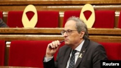 Catalan President Quim Torra attends a session vote on whether former Catalan President Carles Puigdemont and other members of his government can keep their seats as lawmakers while under investigation or in prison on charges of rebellion, at Catalonian regional Parliament in Barcelona, Spain, Oct. 2, 2018. 