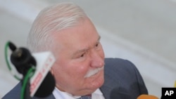 FILE - Former Polish President Lech Walesa speaks to journalists in Warsaw, Poland, Aug. 6, 2015.