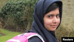 FILE - Malala Yousufzai smiles as she attends school in Edgbaston, central England, in this handout photograph released March 19, 2013.