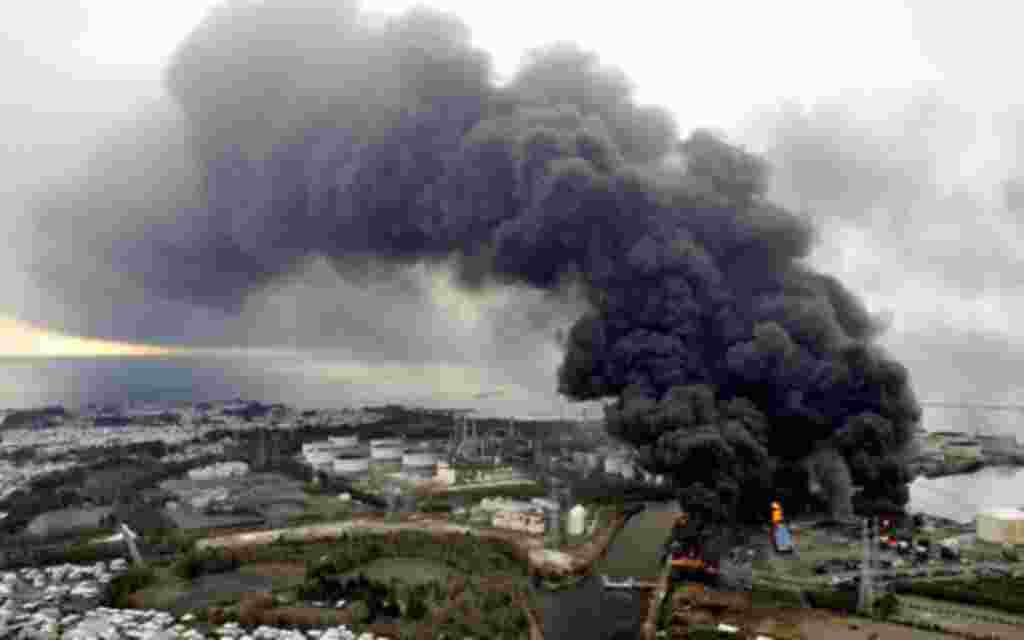 Smoke rises from a burning factory following an earthquake and tsunami in Sendai, northeastern Japan March 12, 2011. Japan confronted devastation along its northeastern coast on Saturday, with fires raging and parts of some cities under water after a mass