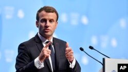 FILE - French President Emmanuel Macron delivers a speech during climate talks in Bonn, Germany, Nov. 15, 2017. 