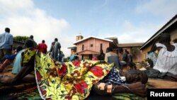 Une malade semble abandonnée à la cour du centre pour maladie mentale de l’hôpital de Bouaké, Côte d’Ivoire, 12 octobre 2002.