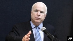 U.S. Senator John McCain talks to reporters during a news conference at the American Centre in Rangoon, June 3, 2011