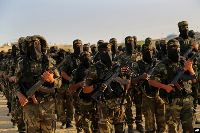 FILE - Palestinian militants of the Islamic Jihad group take part in their military exercises in Deir el-Balah, the central Gaza Strip, Dec. 11, 2014.