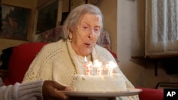 Emma Morano, 117 years old, blows out the candles on her birthday cake in Verbania, Italy, Nov. 29, 2016. 