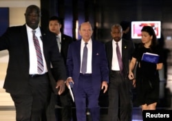FILE - U.S. Commerce Secretary Wilbur Ross (C), a member of the U.S. trade delegation to China, leaves a hotel in Beijing, China, May 3, 2018.