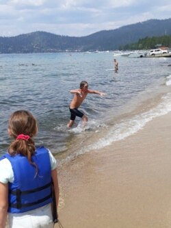 James leaves the water after completing a 12-hour swim across the entire length of Lake Tahoe. (AP Photo/Jillian Savage)