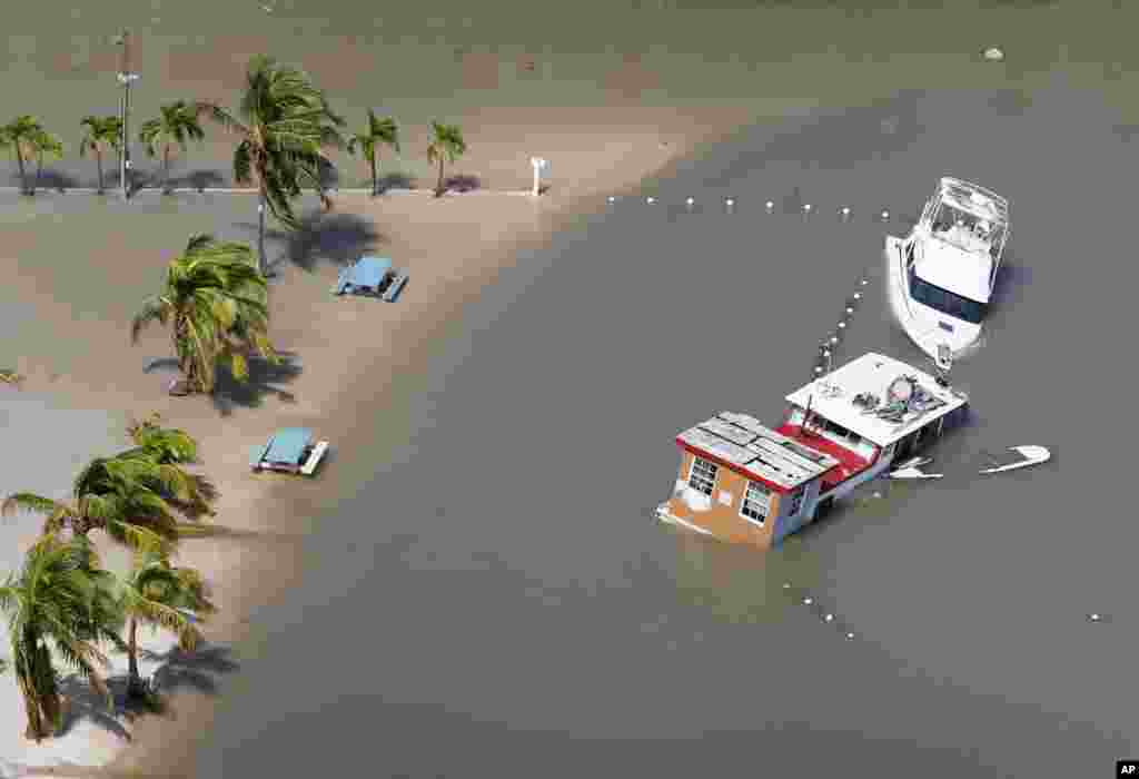 Boats are partially submerged in the wake of Hurricane Irma in Key Largo, Florida, Sept. 11, 2017.