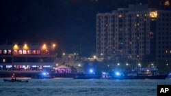 Search-and-rescue boats look for a small plane that went down in the Hudson River, May 27, 2016. 