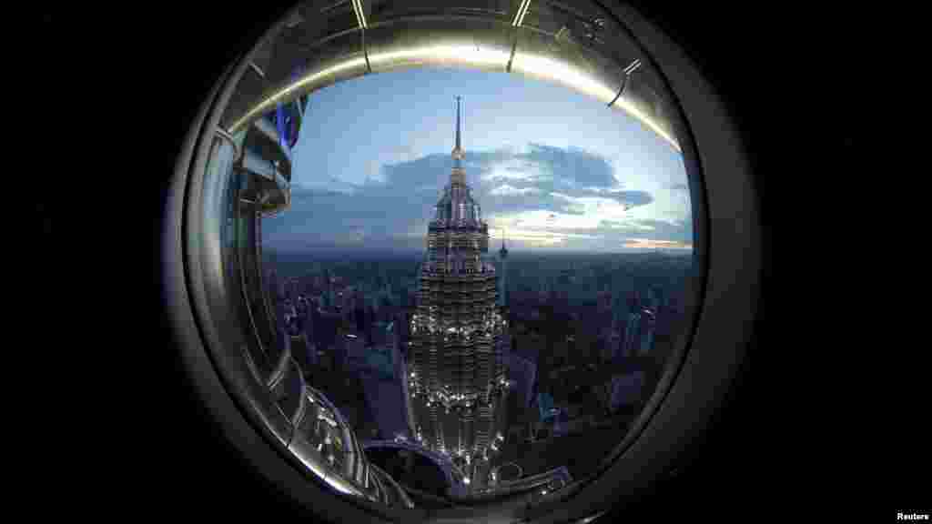 A view of one of the Petronas Towers is seen from a window of its twin building in Kuala Lumpur, Malaysia.