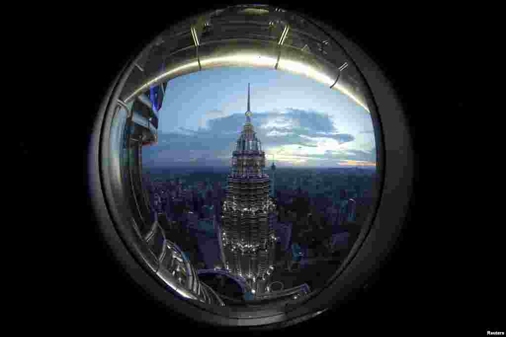 A view of one of the Petronas Towers is seen from a window of its twin building in Kuala Lumpur, Malaysia.