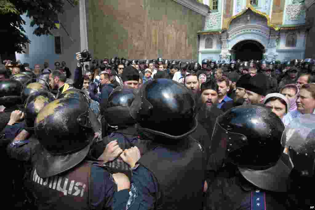 Riot police surround the Kyiv Pechersk Lavra, an Orthodox Christian monastery, where radical activists were protesting separatists, June 22, 2014. 