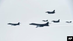 U.S. Air Force B-1B Lancer bombers, left and second from left, fly with South Korean and U.S. fighter jets over the Korean Peninsula, South Korea, July 8, 2017, in this photo provided by South Korea Defense Ministry.