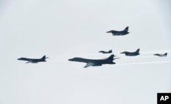 FILE - U.S. Air Force B-1B Lancer bombers, left and second from left, fly with South Korean and U.S. fighter jets over the Korean Peninsula, South Korea, July 8, 2017, in this photo provided by South Korea Defense Ministry.