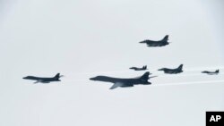 FILE - U.S. Air Force B-1B Lancer bombers, left and second from left, fly with South Korean and U.S. fighter jets over the Korean Peninsula, South Korea, July 8, 2017, in this photo provided by South Korean Defense Ministry.
