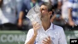 Novak Djokovic, of Serbia, kisses the trophy after defeating Andy Murray, of Britain, during the men's singles final of the Sony Ericsson tennis tournament, Sunday, April 1, 2012, in Key Biscayne, Fla. Djokovic won 6-1, 7-6 (4). (AP Photo/Lynne Sladky)