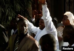 Gambia's Adama Barrow waves after his inauguration at Gambia's embassy in Dakar, Senegal, Jan. 19, 2017.