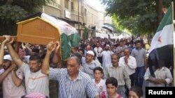 Residents carry the coffin of Muhammad Mousa, whom protesters say was killed by forces loyal to Syria's President Bashar al-Assad, during his funeral in Yabroud near Damascus July 21, 2012.