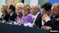 German Chancellor Angela Merkel (4th L), France's President Francois Hollande (2nd L), Lithuania's President Dalia Grybauskaite (3rd L), European Commission President Jose Manuel Barroso (2nd R), European Parliament President Martin Schulz (R), European Council President Herman Van Rompuy (3rd R) and German Labour Minister Ursula von der Leyen attend a news conference after an EU conference on Youth Unemployment in Berlin, July 3, 2013.