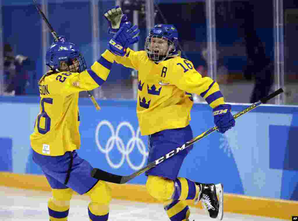 Pernilla Winberg (16) celebrates with Hanna Olsson (26), of Sweden, after scoring a goal against the combined Koreas during the second period of the preliminary round of the women's hockey game at the 2018 Winter Olympics in Gangneung, South Korea.