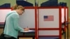 FILE - A woman casts marks her ballot during primary voting in Durham, N.C., May 8, 2018. 