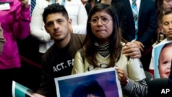 FILE - Dreamer Karen Caudillo, 21, of Florida is comforted by Jairo Reyes, 25, of Rogers, Ark., as Sen. Kamala Harris, D-Calif., accompanied by fellow congressional Democrats, speaks during a news conference on Capitol Hill in Washington, Sept. 6,