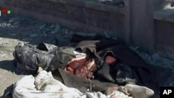 An image grab taken off the official Syrian TV shows the bodies of the victims covered with blankets at the scene of a blast in Syria's second largest city of Aleppo, February 10, 2012.