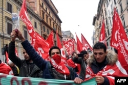 People take part in an anti-fascist march called by Italian left-wing parties and union organizations, in central Rome, Italy, Feb. 24, 2018.