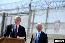 Secretary of Homeland Security John Kelly speaks as Attorney General Jeff Sessions listens as they brief the media during visit to the U.S. Mexico border fence in San Diego, California, U.S. April 21, 2017.