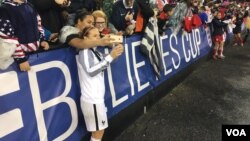 French player takes a selfie with fans at RFK Stadium in Washington after France defeated the USA, 3-0, to win the SheBelieves Cup.