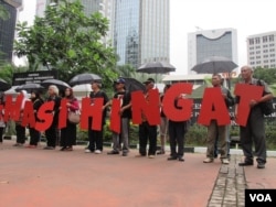 Komisi untuk Orang Hilang dan Korban Tindak Kekerasan (Kontras) bersama korban pelanggaran HAM berat masa lalu melakukan aksi di depan Kantor Kementerian Koordinator Politik Hukum dan Keamanan, Jakarta Kamis 31/3 (VOA/Fathiyah).