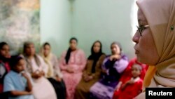 A counselor talks to a group of women to try to convince them that they should not have female genital mutilation performed on their daughters, in Minia, Egypt, Jun. 2006.