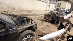 Damaged cars at the site of a bomb explosion in Suleja, Nigeria, February 19, 2012.