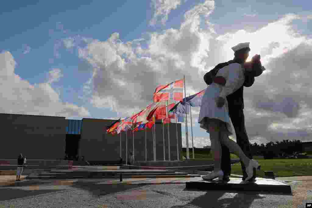 &quot;Unconditional Surrender,&quot; an 8-meter (25-foot) cast-bronze sculpture, based on the iconic photo by Alfred Eisenstaedt, showing a sailor and a nurse in a lip-locked embrace on VJ Day, outside the Caen Memorial in Normandy, France. 