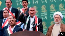 FILE - Hadi al-Amiri, center, speaks to his followers during his political block campaign rally in Baghdad, Iraq, May 7, 2018.