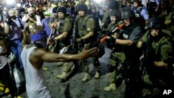 Police arrest a man as they disperse a protest in Ferguson, Mo., Aug. 20, 2014. 