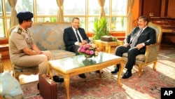 In this photo released by the Egyptian Presidency, July 1, 2013, Egyptian President Mohammed Morsi, right, meets with Prime Minister Hesham Kandil, center, and Egyptian Minister of Defense, Lt. Gen. Abdel-Fattah el-Sissi, left in Cairo. 