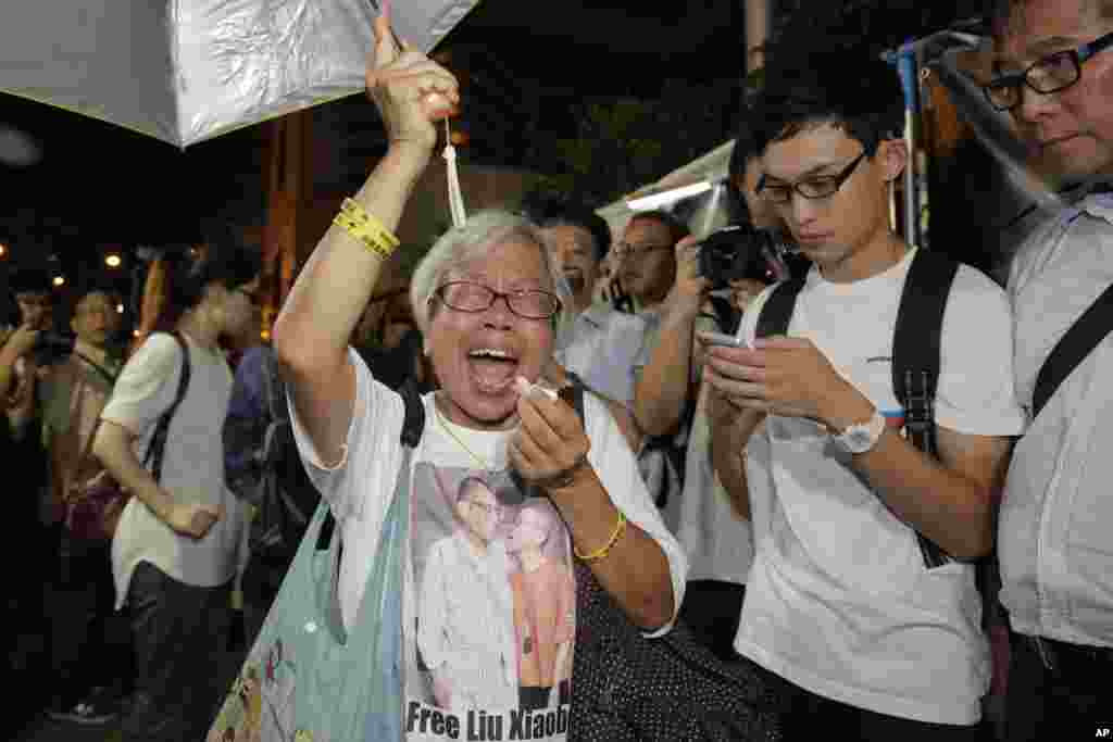 A protester cries as she mourns jailed Chinese Nobel Peace laureate Liu Xiaobo during a demonstration outside the Chinese liaison office in Hong Kong.