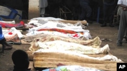 Bodies of victims of armed raiders covered-over with cloth are lined-up for identification on September 19, 2011 in the capital Bujumbura.