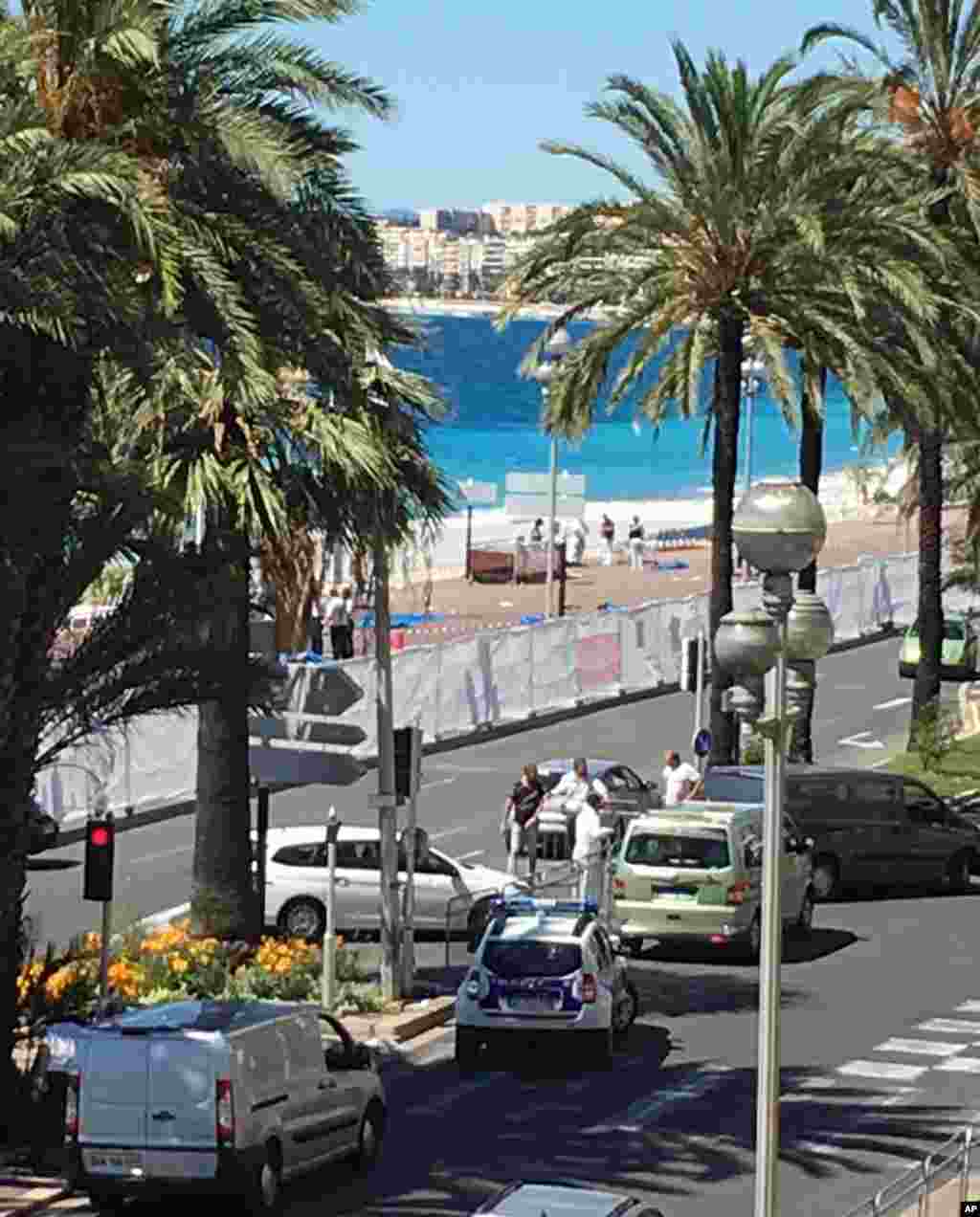 Forensic officials work on the beach next to the famed Promenade des Anglais, scene of the truck attack, in Nice, southern France on July 15, 2016.