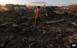A man walks through the scorched ground of the open-air San Pablito fireworks market, in Tultepec, outskirts of Mexico City, Mexico, Dec. 20, 2016. An explosion ripped through Mexico’s best-known fireworks market where most of the fireworks stalls were completely leveled.