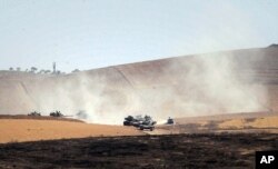 Turkish military move inside Syria near the Turkish border town of Karkamis, Turkey, Friday, Aug. 26, 2016.