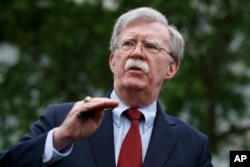 National security adviser John Bolton talks to reporters about Venezuela, outside the White House, May 1, 2019, in Washington.